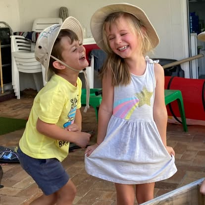 Two children laughing and playing together at Play Matters