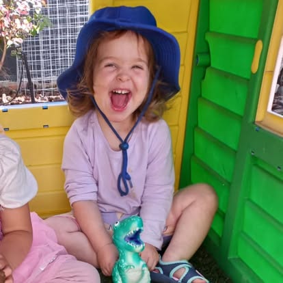 A little one laughing with joy during play at Play Matters